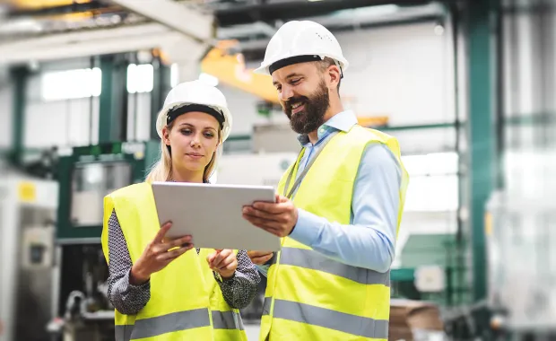 Engineers with tablet in a factory
